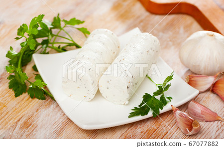 Soft goat cheese with herbs and garlic Soft goat cheese with herbs and garlic 67077882