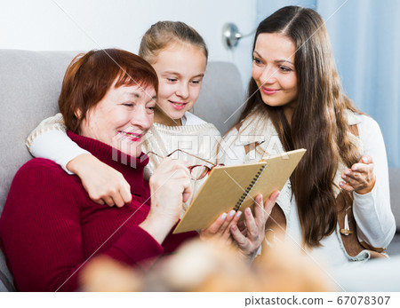 Three generations of happy family reading Three generations of happy family reading 67078307