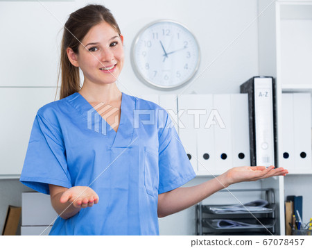 Female doctor making welcome gesture 67078457