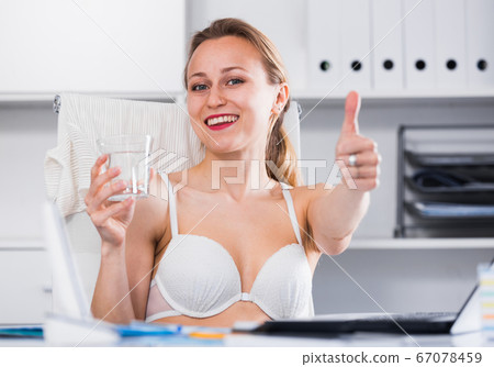 Woman working in bra at the laptop 67078459