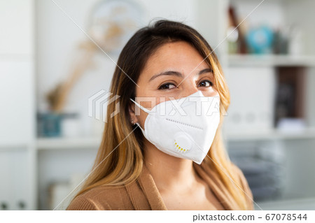 Young mexican woman in mask in the modern office 67078544