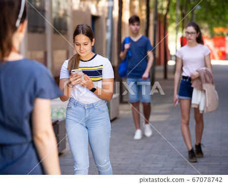 Young teen girl walks down the street Young teen girl walks down the street 67078742