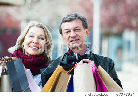 Couple with shopping bags outdoors Couple with shopping bags outdoors 67078934