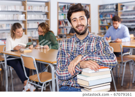 Portrait of smiling bearded man with books Portrait of smiling bearded man with books 67079161
