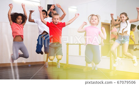 Boys and girls jumping in dance studio Boys and girls jumping in dance studio 67079506