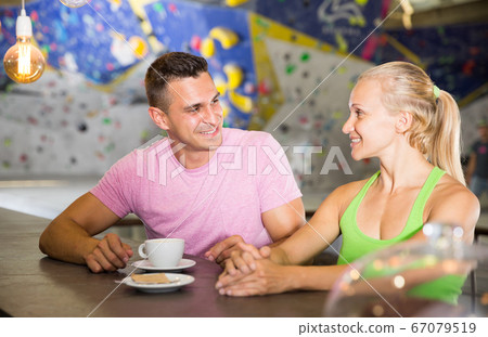 Couple drinking coffee at bouldering gym Couple drinking coffee at bouldering gym 67079519