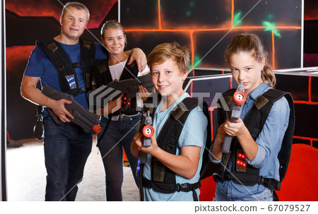 Glad boy and girl posing with laser guns Glad boy and girl posing with laser guns 67079527
