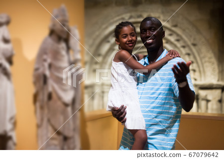 Father and daughter looking at exhibits Father and daughter looking at exhibits 67079642
