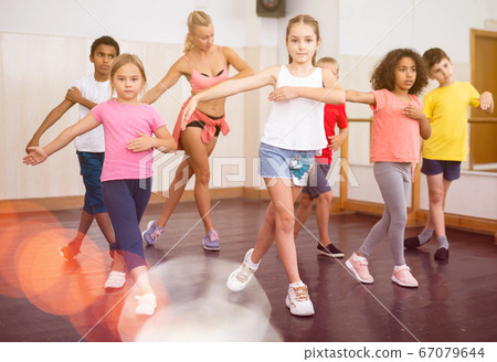Boys and girls training in dance studio Boys and girls training in dance studio 67079644