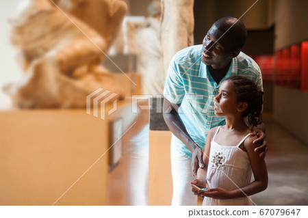 Man and his daughter visiting Art Museum 67079647