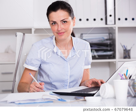 cheerful woman working in the office cheerful woman working in the office 67079648