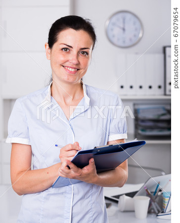 Portrait of adult female in the office 67079654