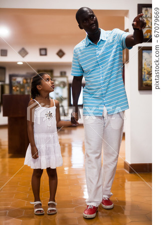 Father and daughter visiting museum of arts Father and daughter visiting museum of arts 67079669
