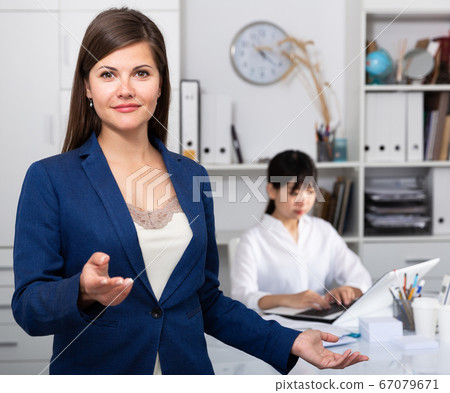 Portrait of successful confident business woman in office interior 67079671