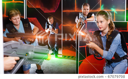 Happy teen brother and sister standing with laser pistols during Happy teen brother and sister standing with laser pistols during 67079708