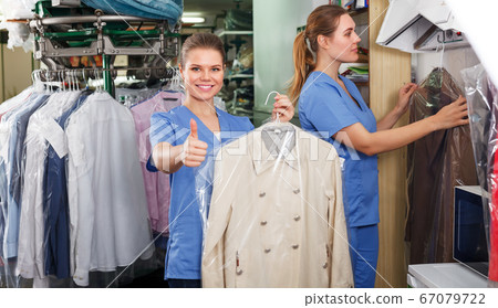 Two workers showing clean clothing 67079722