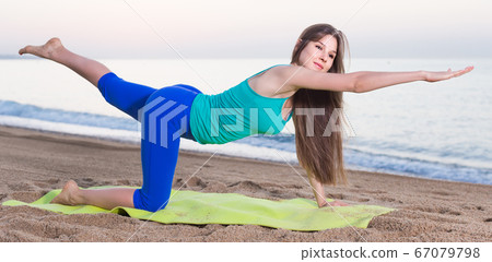 Female 20-25 years old is doing excercises on endurance Female 20-25 years old is doing excercises on endurance 67079798