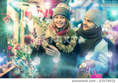 Joyful girl and boy choosing toys and Christmas tree Joyful girl and boy choosing toys and Christmas tree 67079918