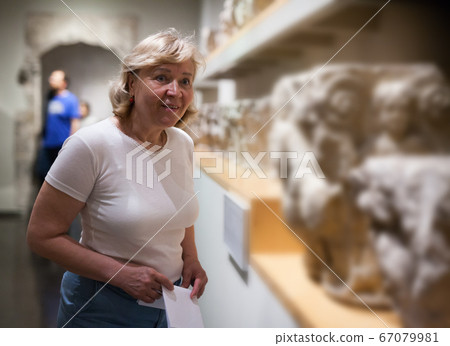 Mature woman visiting exposition Mature woman visiting exposition 67079981