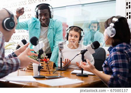 Scandal interview. Two outraged guests answering provocative questions of radio hosts during live radio show 67080137