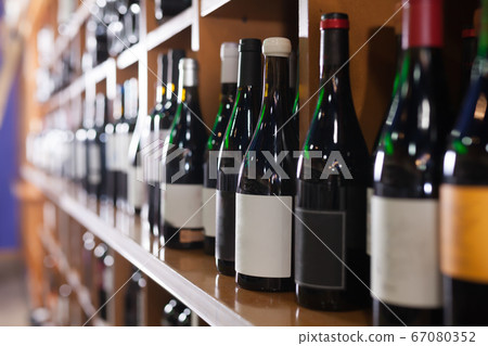 Racks with variety red and white wine bottles Racks with variety red and white wine bottles 67080352