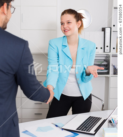 Businesswoman meetings male colleague 67080354