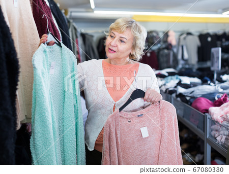 female choosing knitwear jumper female choosing knitwear jumper 67080380