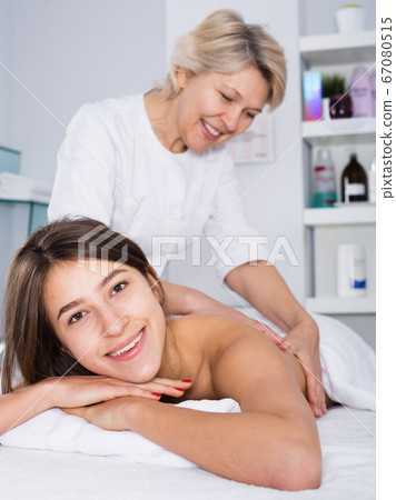 Young woman having massage 67080515