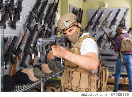 men in army uniform with gun in military market men in army uniform with gun in military market 67080516