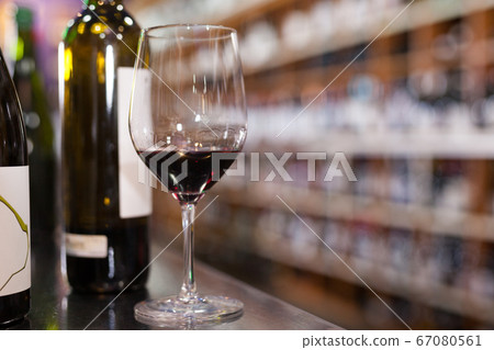 Red wine tasting glass and bottles Red wine tasting glass and bottles 67080561