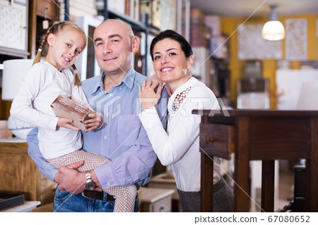 Family is choosing new furniture Family is choosing new furniture 67080652