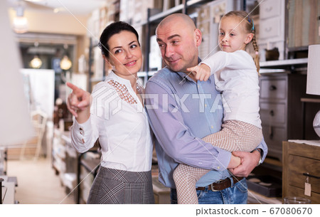 couple with the girl is choosing furniture couple with the girl is choosing furniture 67080670