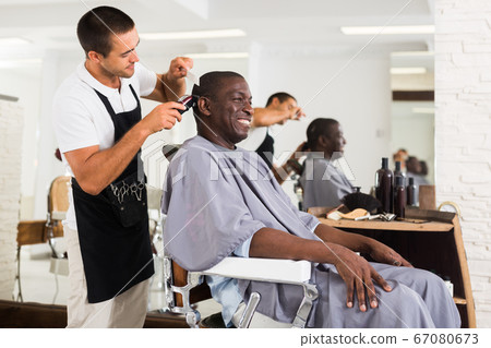 African male client getting haircut African male client getting haircut 67080673