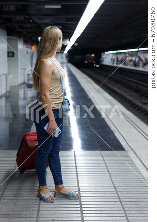 Woman on underground platform waiting train Woman on underground platform waiting train 67080760