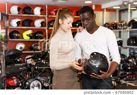 couple choosing motorcycle accessories and riding gear couple choosing motorcycle accessories and riding gear 67080802