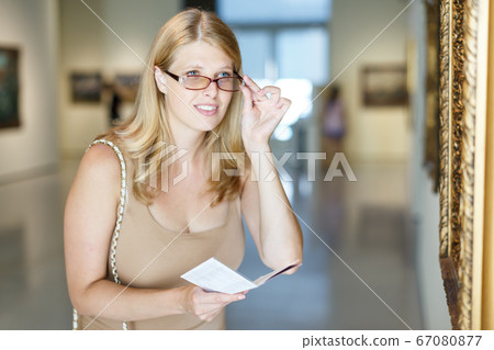 Woman with poor eyesight visiting museum 67080877