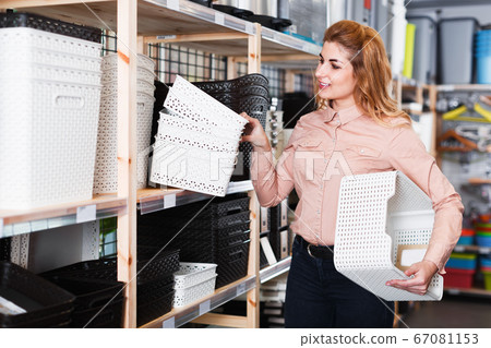 Girl choosing boxes storage Girl choosing boxes storage 67081153