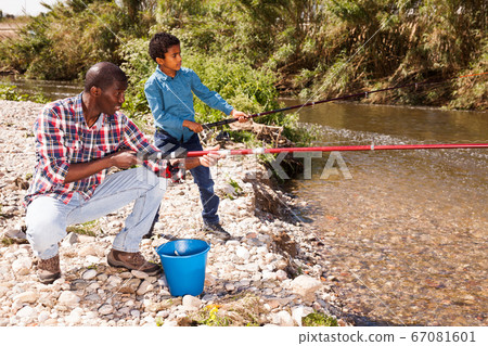 Man and boy fishing with rods Man and boy fishing with rods 67081601