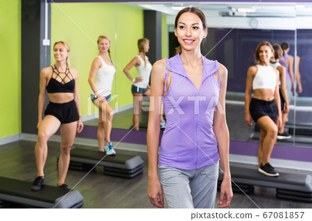 Girl during workout with step platforms in gym Girl during workout with step platforms in gym 67081857