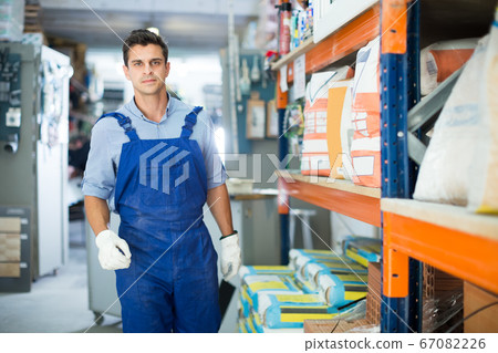 Young male in uniform on his workplace Young male in uniform on his workplace 67082226