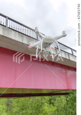 Inspection of bridge by drone (viewed from the ground) Inspection of bridge by drone (viewed from the ground) 67083740