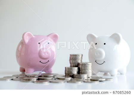 Piggy bank with a pile of coins Steps into a business that is growing to be successful and economical for retirement concepts Piggy bank with a pile of coins Steps into a business that is growing to be successful and economical for retirement concepts 67085260