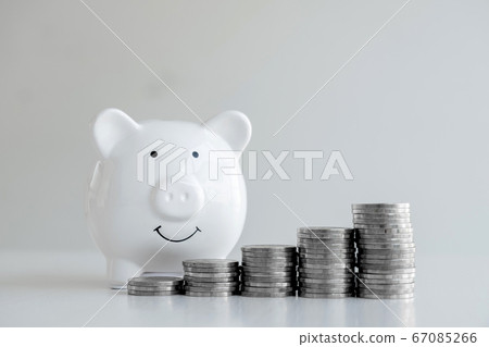 Piggy bank with a pile of coins Steps into a business that is growing to be successful and economical for retirement concepts 67085266