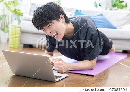 Young men training at home 67085304