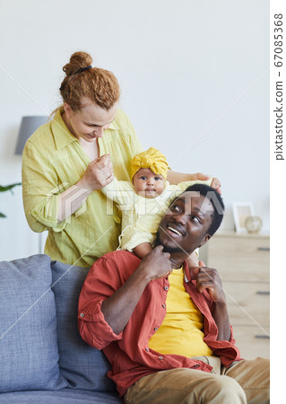 Parents playing with child Parents playing with child 67085368