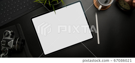 Blank screen tablet on dark modern workspace with Blank screen tablet on dark modern workspace with 67086021