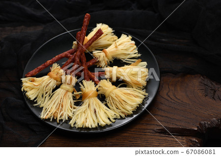 Witches Broom of smoked cheese suluguni and salami Witches Broom of smoked cheese suluguni and salami 67086081
