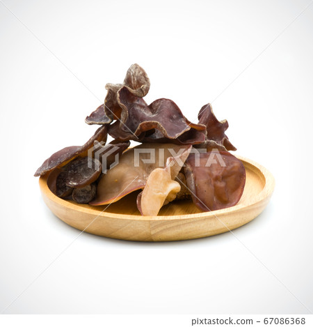 black fungus fresh In a wooden tray  on the white 67086368