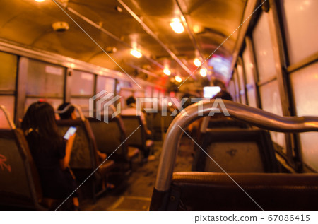 Blurry Light Inside Bus of the Night in Blurry Background. Blurry Light Inside Bus of the Night in Blurry Background. 67086415