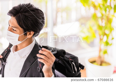 A young man wearing a mask (carrying a backpack) A young man wearing a mask (carrying a backpack) 67086616